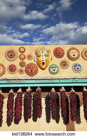 Picture - Ornamental masks and hanging dried peppers. Fotosearch