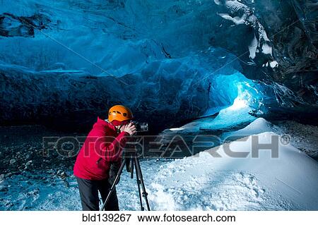 Photographer taking photograph in ice cave View Large Photo Image Stock Photo - Photographer taking photograph in ice cave. Fotosearch