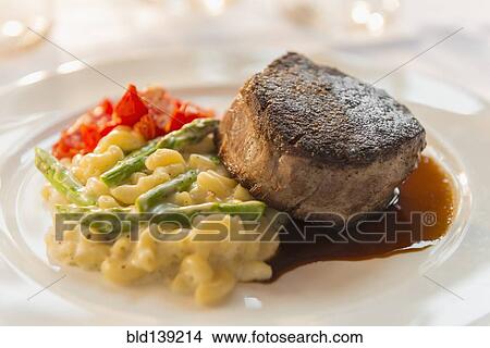 Plate of seared meat with vegetables and pasta View Large Photo Image Picture - Plate of seared meat with vegetables and pasta. Fotosearch