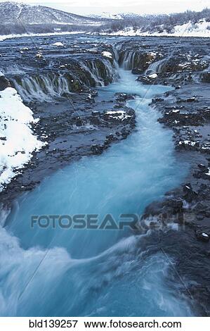Stock Photo - River flowing from waterfall, Bruarfoss, Sudhurland, Iceland. Fotosearch