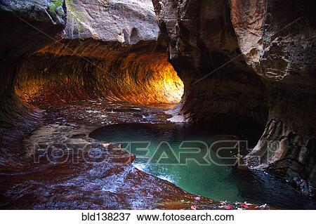 Stock Photo - Rock formations and pool in cave, Zion National Park, Utah, United States. Fotosearch