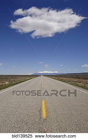 Stock Photography - Rural field under blue sky in desert landscape. Fotosearch