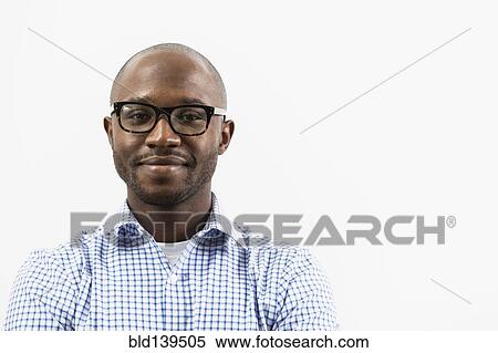Stock Photography - Smiling Black man wearing eyeglasses. Fotosearch