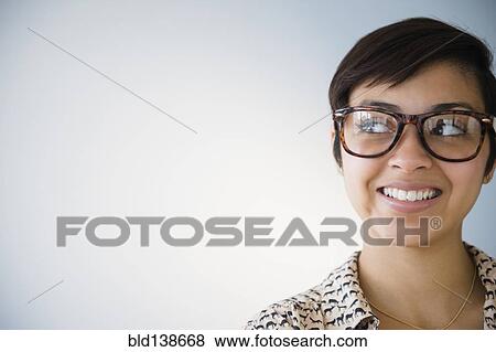 Stock Photo - Smiling mixed race woman wearing eyeglasses. Fotosearch