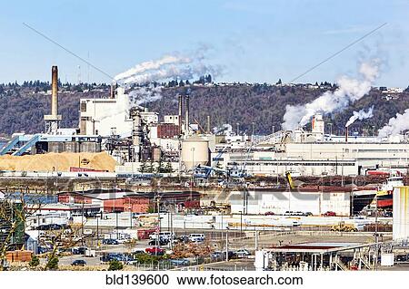 Smoke billowing from smoke stacks in industrial area View Large Photo Image Stock Image - Smoke billowing from smoke stacks in industrial area. Fotosearch
