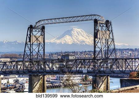Snowy mountain viewed through urban bridge, Tacoma, Washington, United States View Large Photo Image Stock Photo - Snowy mountain viewed through urban bridge, Tacoma, Washington, United States. Fotosearch