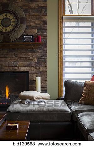 Stock Photo - Sofa and fireplace in living room. Fotosearch