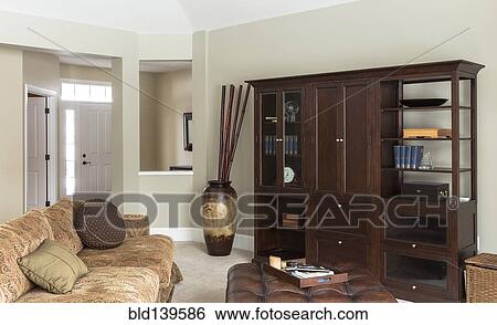 Sofa, ottoman and cabinets in modern living room View Large Photo Image Stock Photograph - Sofa, ottoman and cabinets in modern living room. Fotosearch