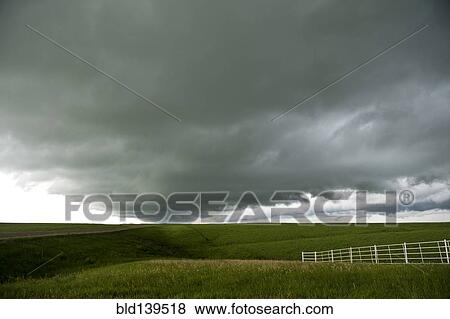 Stock Photo - Storm clouds over rural landscape. Fotosearch