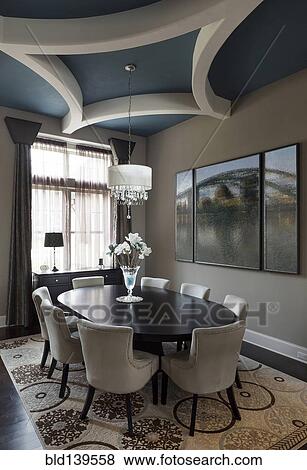 Table and chairs with paintings in dining room View Large Photo Image Stock Photo - Table and chairs with paintings in dining room. Fotosearch