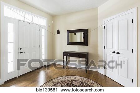 Table and mirror in modern entryway View Large Photo Image Stock Image - Table and mirror in modern entryway. Fotosearch