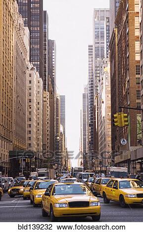 Taxis driving on city street, New York City, New York, United States View Large Photo Image Stock Image - Taxis driving on city street, New York City, New York, United States. Fotosearch