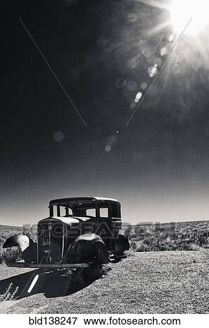 Vintage car missing tires in remote field View Large Photo Image Stock Photo - Vintage car missing tires in remote field. Fotosearch