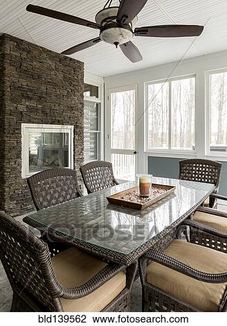 Stock Image - Wicker dining table and chairs in dining room. Fotosearch