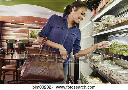 African American woman choosing food in deli View Large Photo Image Stock Photo - African American woman choosing food in deli. Fotosearch