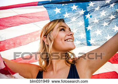 Caucasian teenage girl holding American flag View Large Photo Image Stock Photo - Caucasian teenage girl holding American flag. Fotosearch