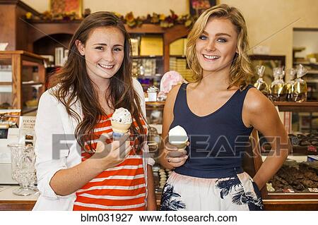 Caucasian teenage girls eating ice cream in candy shop View Large Photo Image Stock Photo - Caucasian teenage girls eating ice cream in candy shop. Fotosearch