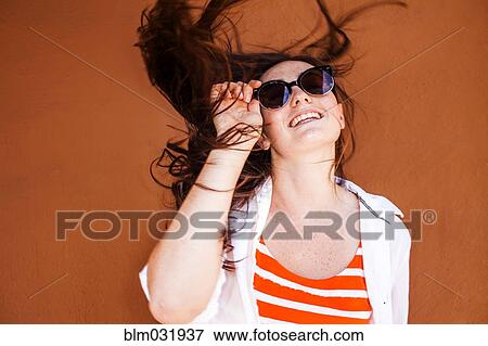 Stock Photo - Caucasian woman wearing sunglasses. Fotosearch