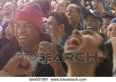 Fans cheering at American football game View Large Photo Image Stock Image - Fans cheering at American football game. Fotosearch
