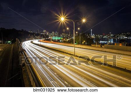 Long exposure of traffic on urban highway and city skyline at night, Seattle, Washington, United States View Large Photo Image Stock Photography - Long exposure of traffic on urban highway and city skyline at night, Seattle, Washington, United States. Fotosearch