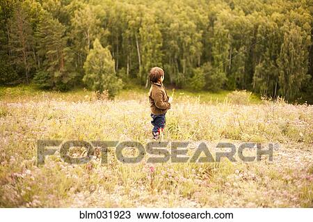Mixed race boy standing in rural field View Large Photo Image Stock Image - Mixed race boy standing in rural field. Fotosearch