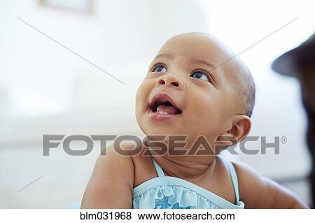 Stock Photo - Mixed race girl looking up. Fotosearch