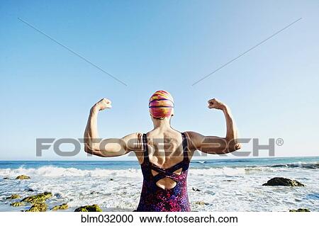 Older Caucasian woman flexing her muscles on beach View Large Photo Image Stock Image - Older Caucasian woman flexing her muscles on beach. Fotosearch
