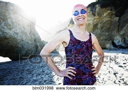 Older Caucasian woman wearing goggles and swimsuit on beach View Large Photo Image Stock Photo - Older Caucasian woman wearing goggles and swimsuit on beach. Fotosearch