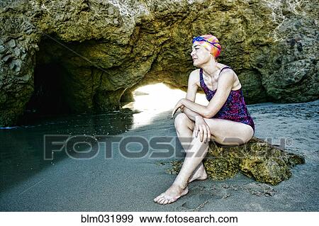 Older Caucasian woman wearing goggles and swimsuit on beach View Large Photo Image Stock Photo - Older Caucasian woman wearing goggles and swimsuit on beach. Fotosearch