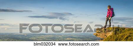 Panoramic view of hiker overlooking remote landscape View Large Photo Image Picture - Panoramic view of hiker overlooking remote landscape. Fotosearch