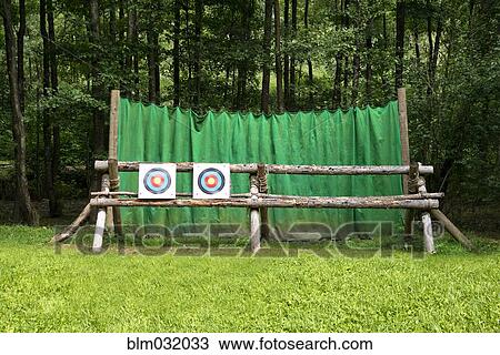 Stock Image - Targets on fence at archery range. Fotosearch