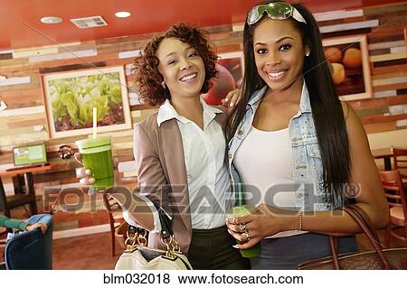 Women having juice together in cafe View Large Photo Image Stock Photo - Women having juice together in cafe. Fotosearch