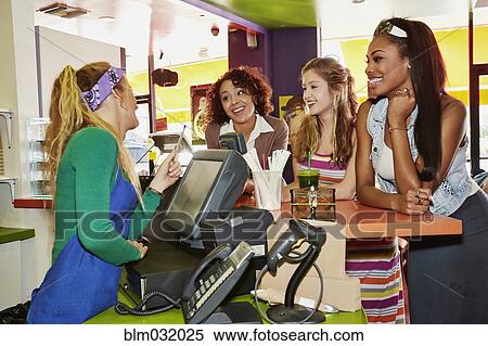 Stock Photography - Women ordering from server in cafe. Fotosearch