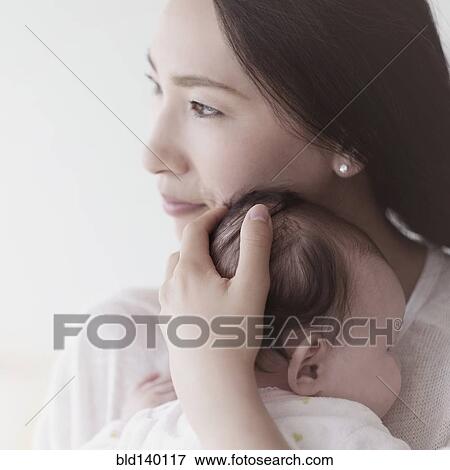 Stock Photo - Asian mother holding baby. Fotosearch