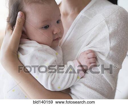 Stock Photo - Asian mother holding baby. Fotosearch