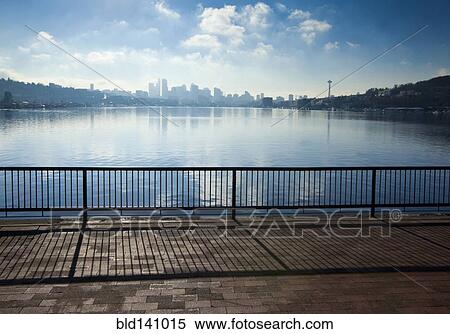 Stock Photography - Banister overlooking Seattle city skyline from urban waterfront, Washington, United States. Fotosearch