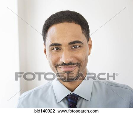 Stock Image - Black businessman smiling. Fotosearch