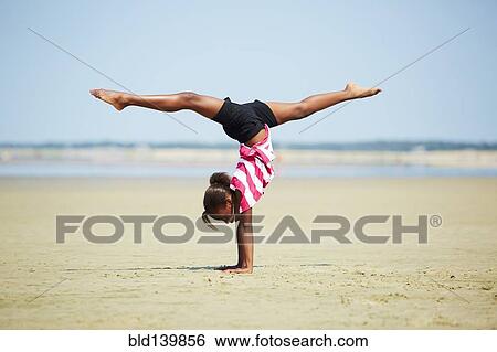 Black girl doing handstand on beach View Large Photo Image Stock Photograph - Black girl doing handstand on beach. Fotosearch