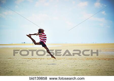 Black girl jumping for joy on beach View Large Photo Image Stock Photo - Black girl jumping for joy on beach. Fotosearch