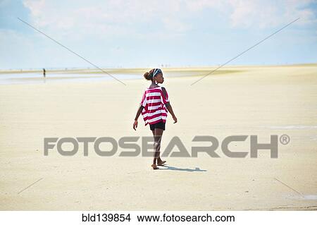 Black girl walking on beach View Large Photo Image Picture - Black girl walking on beach. Fotosearch