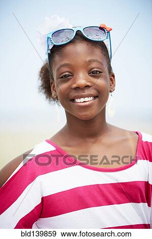 Black girl wearing novelty sunglasses outdoors View Large Photo Image Stock Photo - Black girl wearing novelty sunglasses outdoors. Fotosearch