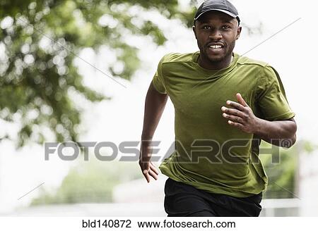 Black man running in park View Large Photo Image Stock Image - Black man running in park. Fotosearch