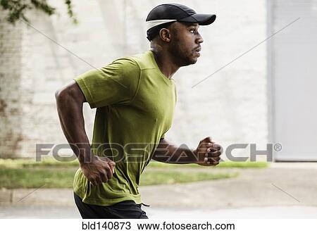 Black man running on city street View Large Photo Image Stock Image - Black man running on city street. Fotosearch