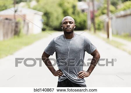 Stock Photo - Black runner resting on city street. Fotosearch