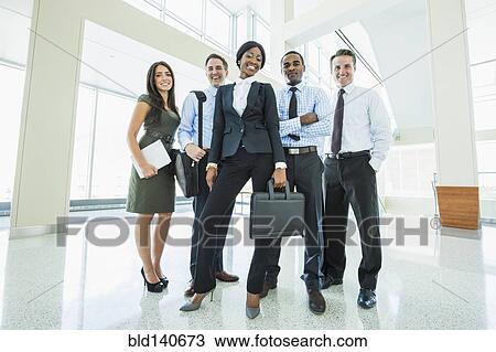 Business people smiling in office lobby View Large Photo Image Stock Image - Business people smiling in office lobby. Fotosearch