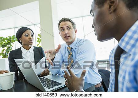 Stock Photo - Business people talking in meeting. Fotosearch