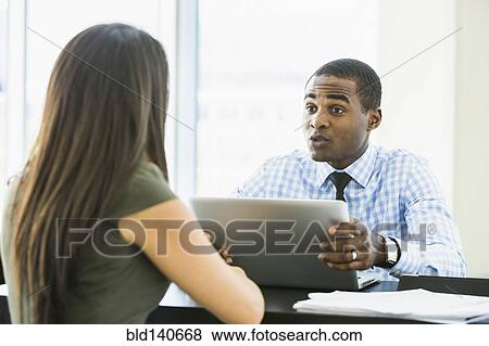 Stock Photo - Business people talking in meeting. Fotosearch