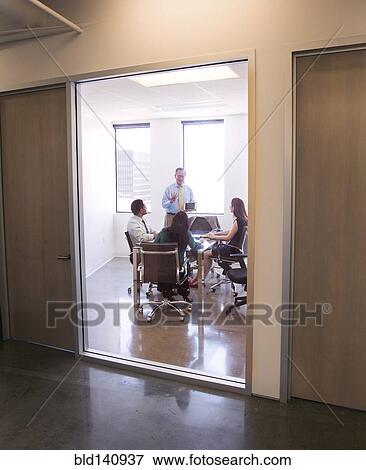 Stock Photo - Business people talking in meeting. Fotosearch