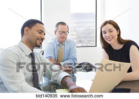 Stock Photography - Business people talking in meeting. Fotosearch