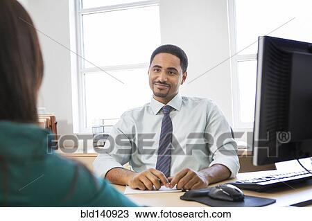 Stock Image - Business people talking in office. Fotosearch